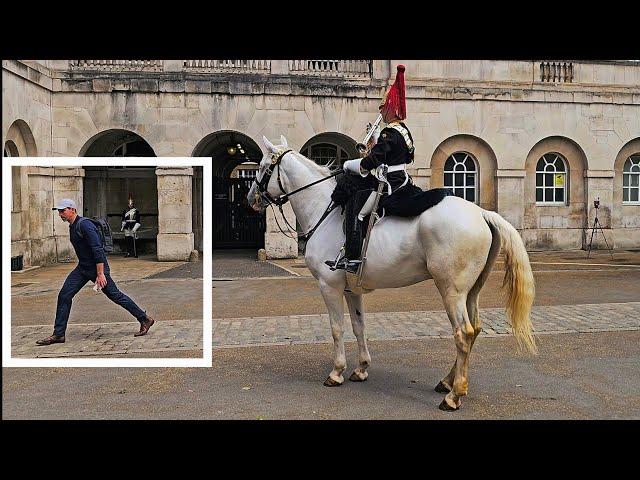 POLICE TELL DOZY TOURIST TO MOVE AS HE ALMOST RUINS THE LONG GUARD at Horse Guards!