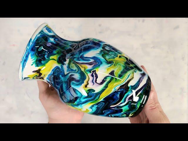 Colorful alcohol ink and epoxy resin on a white vase on a cup turner - greens and blues