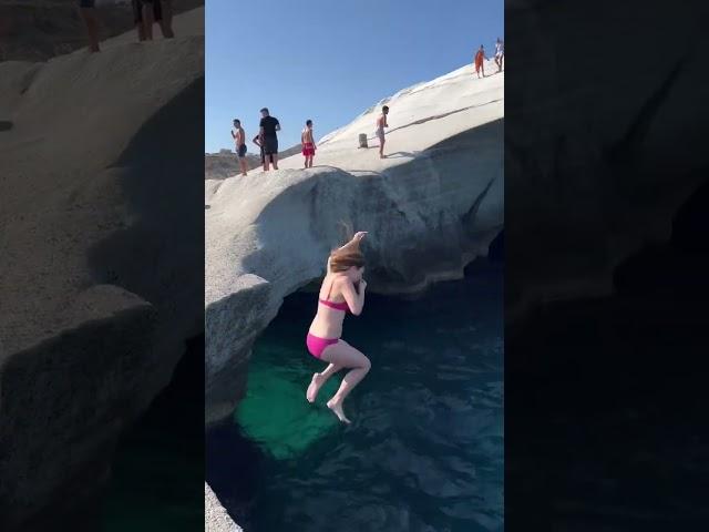 Cliff jumping at Sarakiniko Beach in Milos, Greece