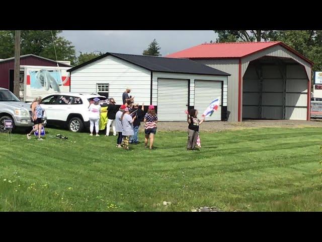 Supporters await former President Donald Trump's motorcade in Potterville