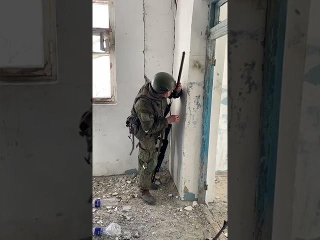 A Russian soldier uses hand-held periscope at the Azovstal plant in Mariupol, Ukraine