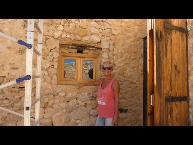 The windows have glass! The stone reveals are done and digging out the problematic roof valley