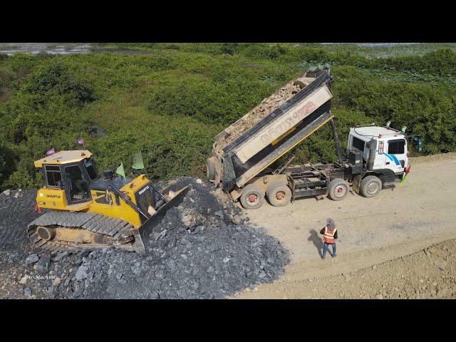 Finalizing Road Construction Power Dozer Pushing Gravel Rock with Heavy Dump Truck Spreading Extreme