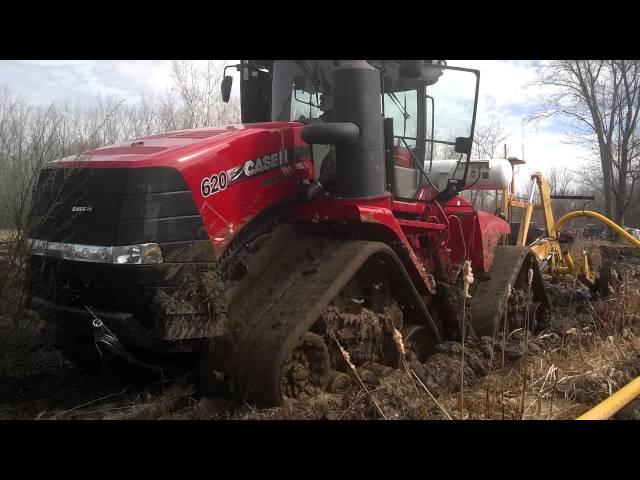 Case IH 620 quad Trac in mud pulling tile plow