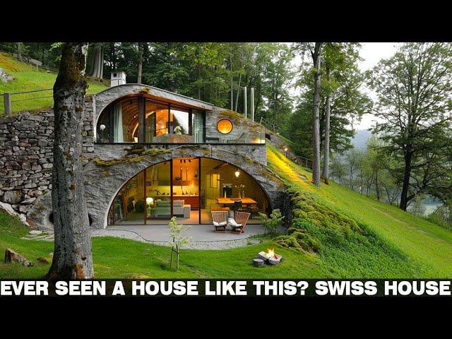 "Can you spot it? A stone house camouflaged on a hillside covered with grass and trees | Swiss house