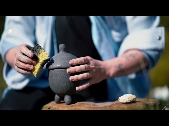 Making a teapot from clay in the nature...