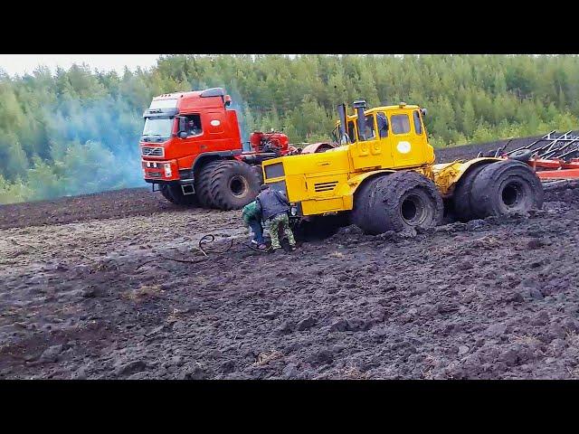 Heavy tractor got stuck in mud! Powerful tractors work in extreme off road conditions.