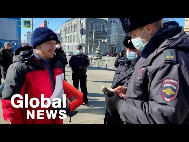 Russian police arrest man holding up blank sheet of paper