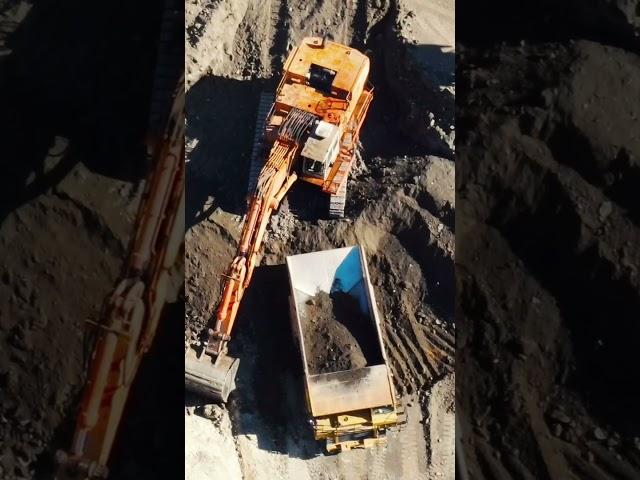 Large Hydraulic Excavator digging and scooping dirt into dump truck #postmymachine