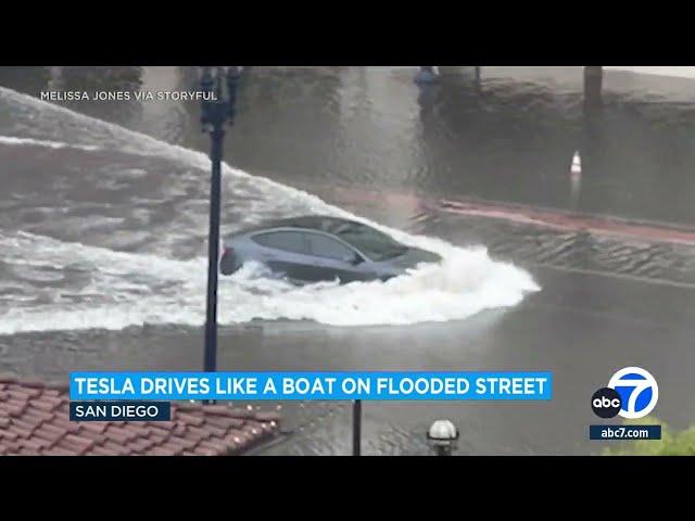 Tesla car plows through flooded San Diego street