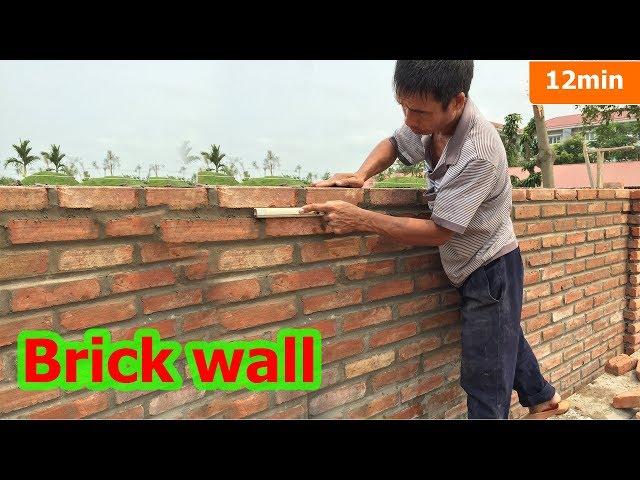 Construction of brick wall. Creating grooves with plastic pipes