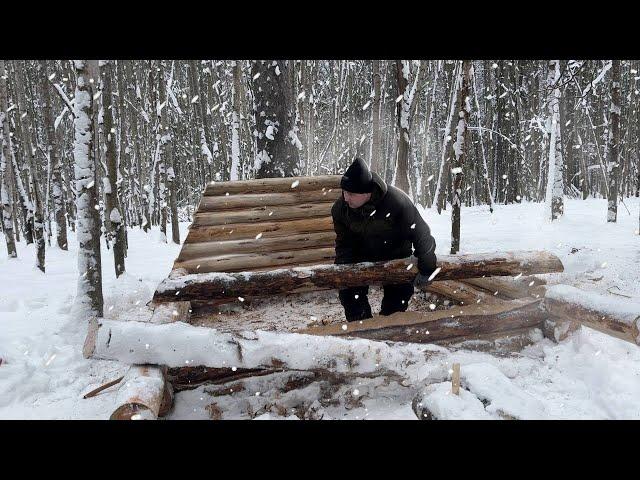 Building a Mini Shelter in a Snowy Ice Forest. Laying And Insulation Of Log Walls