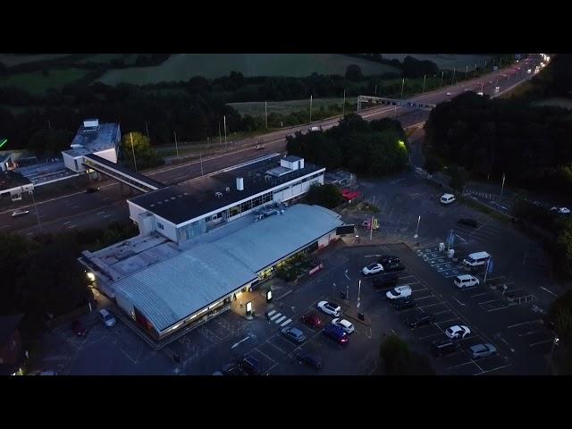 NIGHT DRONE FLYING, over motorway service station in England U.K.