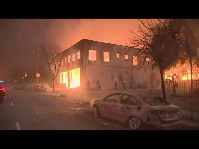 Thousands flee as wildfires burn out of control in and around Los Angeles