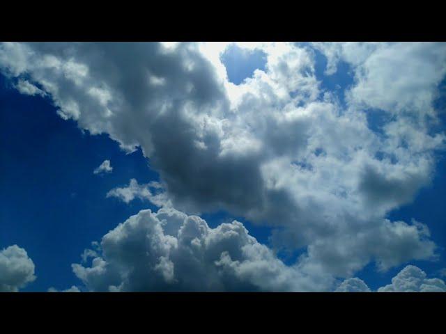 Floating clouds in the blue sky 4K Timelapse