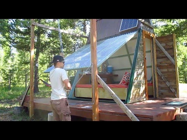 This affordable tiny house/cabin's entire wall swings open on pulleys!