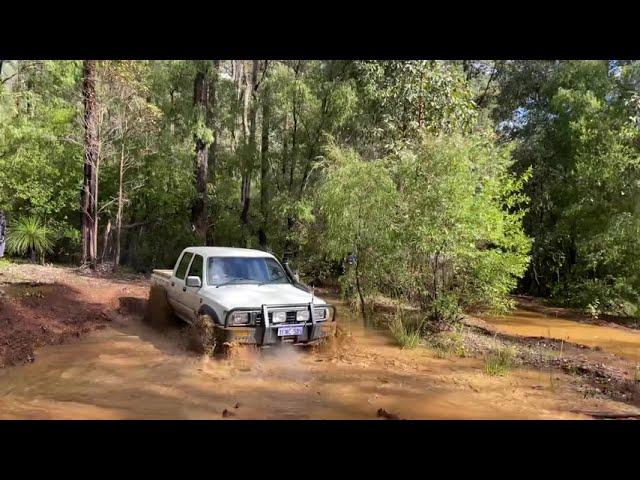 Supercharged 1UZFE V8 Hilux blasting a mud hole!