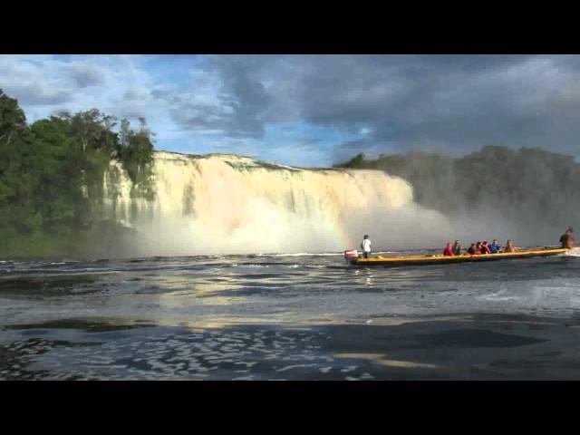 Hacha Falls with rainbow and indian dugout - Canaima National Park Venezuela