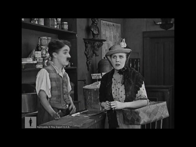 Charlie Chaplin, store clerk, helps forgetful customer (Edna Purviance)