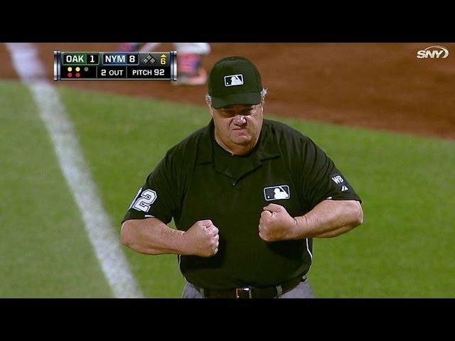 Joe West flexes after getting hit by ball