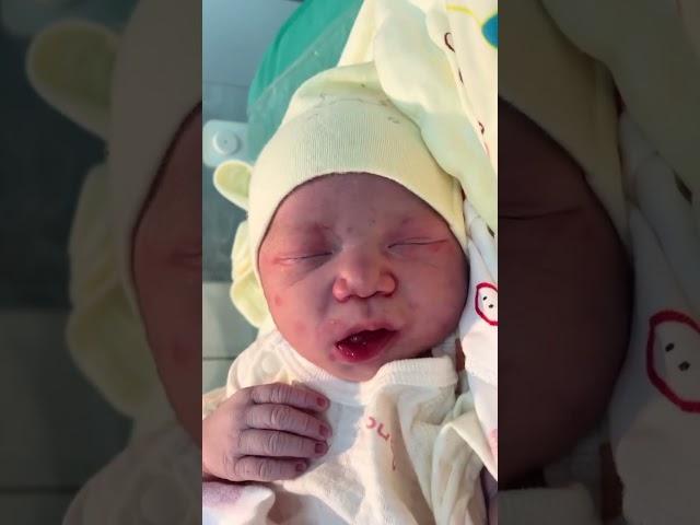 Oh my god, this chubby newborn is sticking out its tongue, so cute!
