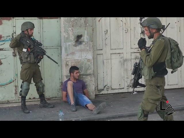 Israeli forces detain two Palestinian youths during clashes, in the West Bank city of Hebron