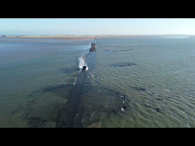 BMW crossing Lindisfarne Causeway as it floods