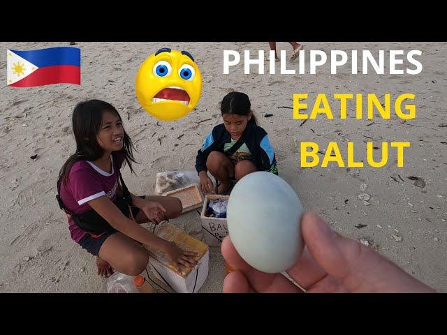 Kids Teach foreigner how to eat balut. White Beach, Moalboal. PHILIPPINES 2024.