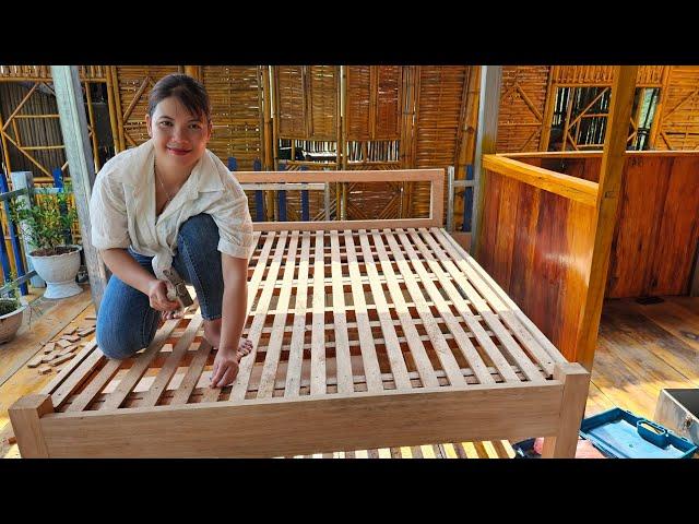 Girl makes wooden bed, daily life on the lake.