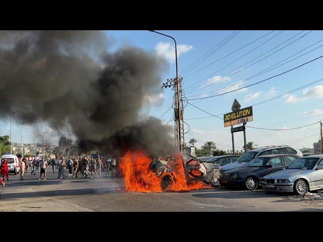 Burning wreckage after Israeli strike kills Hamas official in Lebanon | AFP