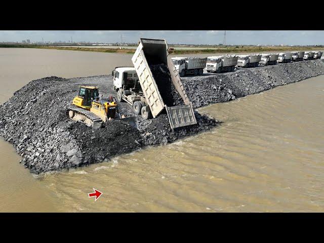 Incredible action of Dumping Rock Into Deep Water by Dump Trucks and Strong Dozer