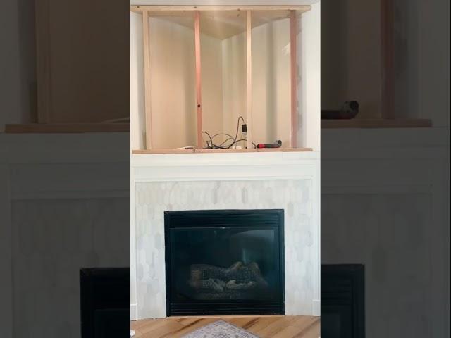 Watch this corner fireplace makeover! Marble picket tile + alder wood mantle