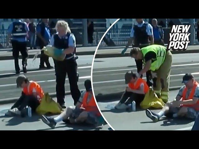 Cop accused of dumping oil on climate protester blocking road