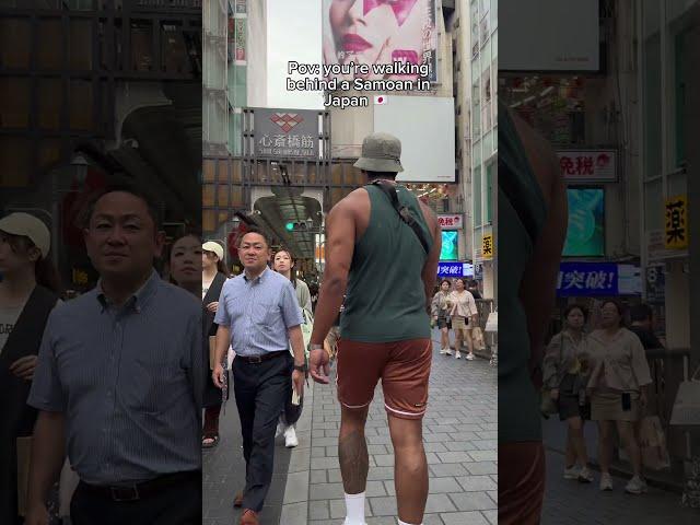 Person is walking through Japan behind a very large guy!
