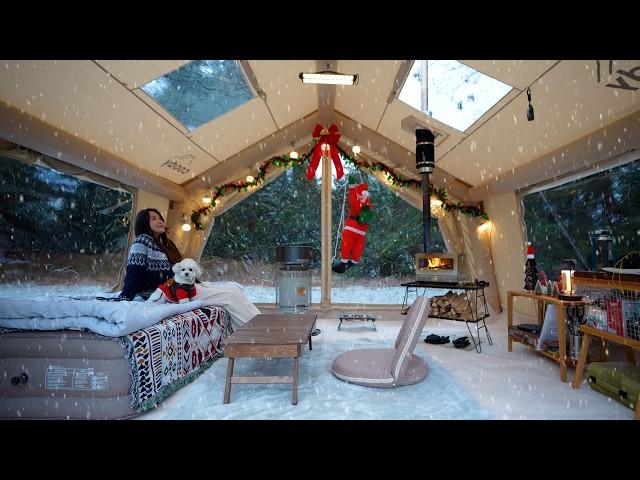 Snowy white Christmas camping in a cozy air tent