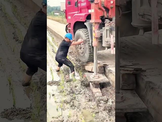 The process of manually fixing the wheel of a truck that has run off the road