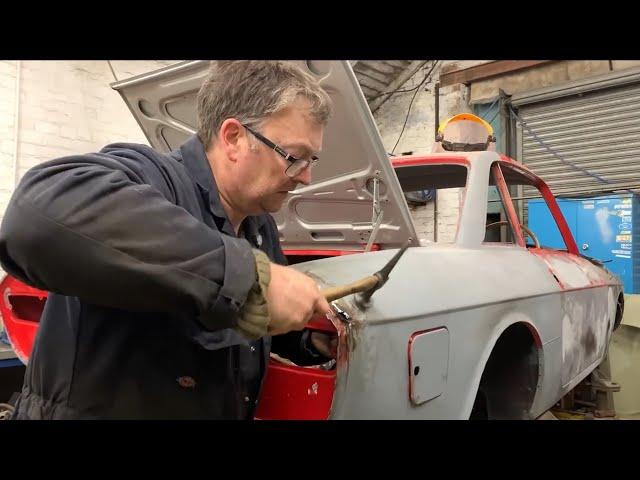 Dent pulling on a classic Lancia Sports Coupe