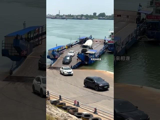 A large truck and a cement concrete mixer truck came by boat and crossed the river. The first sa
