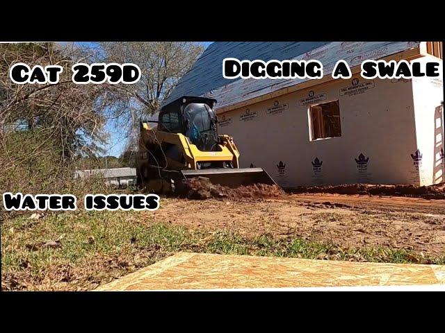 Digging a small swale with my Cat 259D skid steer! Building a Cottage.