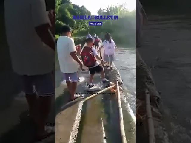 Elementary students in Leyte cross makeshift bridge to get to school on first day of classes