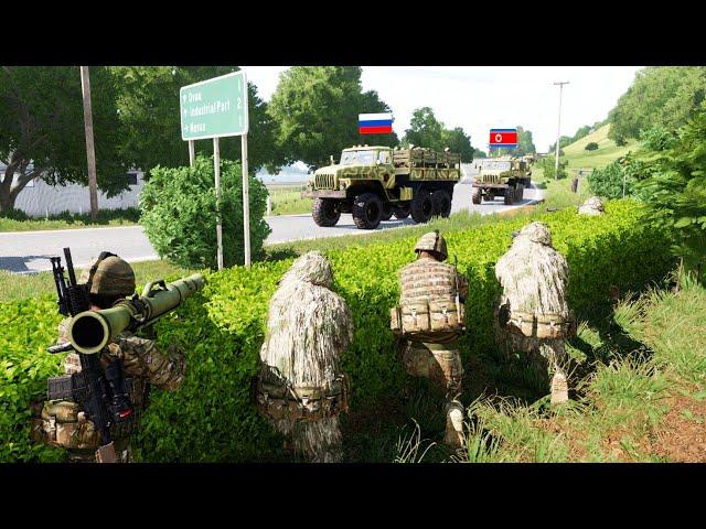 Ukrainian soldiers take cover in the grass of a park to trap a Russian led attack