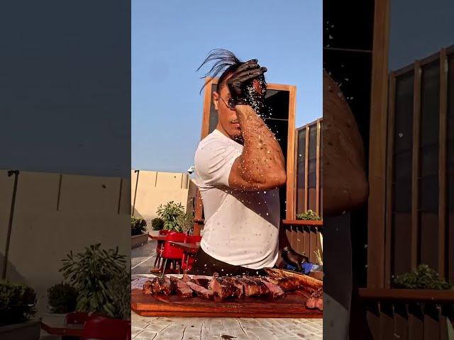 slicing grilled meat and sprinkling salt on the way of chef nusrat - saltbae