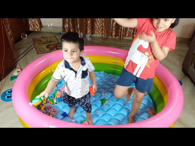 Aru and Avi play with bubbles in an inflatable pool. Fun kids' video!