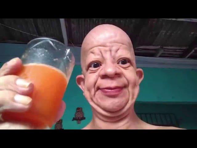 bald guy drinks orange juice