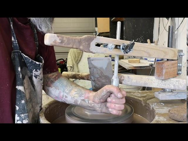 Centering clay using a, strong arm tool