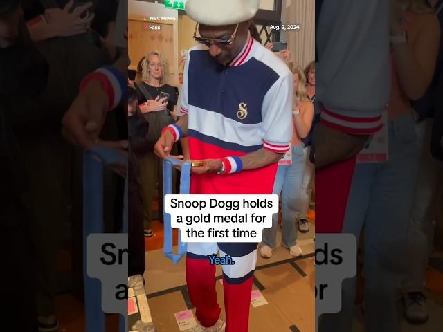 Snoop Dogg holds a gold medal for the first time