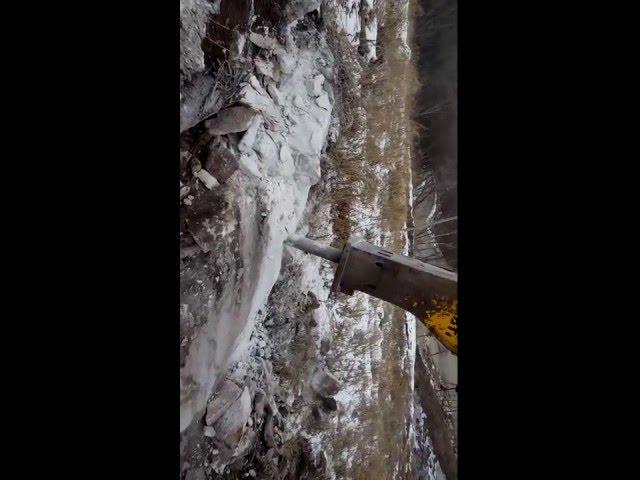 Large rock gets chiseled off by 250 John Deere