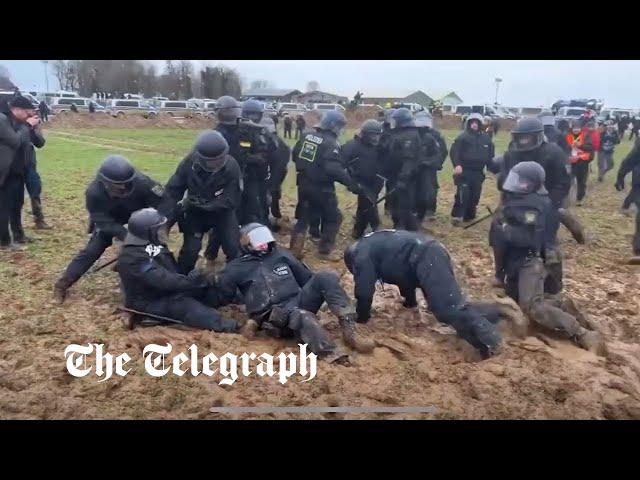 German riot police stuck in mud at coal mine protest