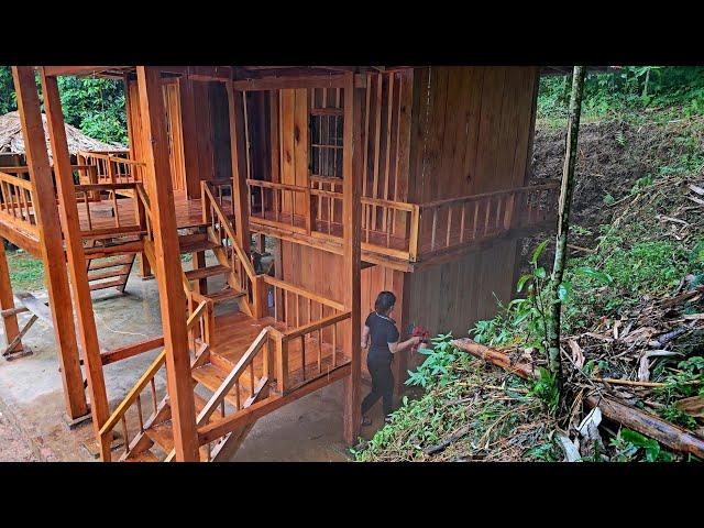 how the girl used wooden planks to make a new door, and finished spray painting the wooden house