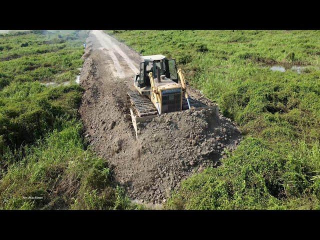 Awesome Mighty bulldozer and truck building new road across forestry swamp